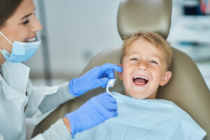 Smiling young boy at a dental appointment with a friendly dentist in Macquarie Fields 