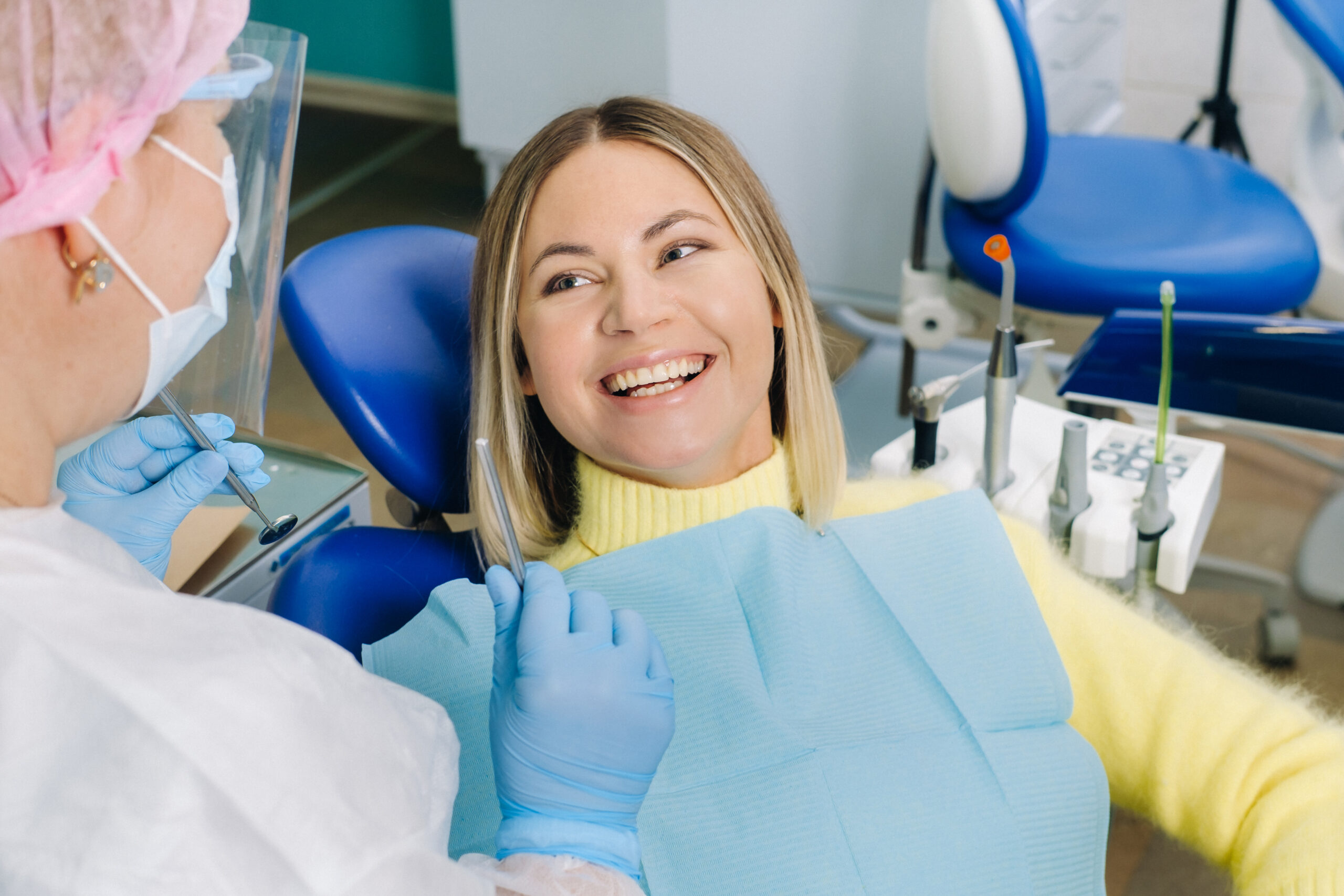 Smiling female patient speaking with her dentist during a consultation in a Macquarie Fields dental clinic